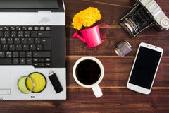 Notebook computer on the desk.USB flash drive stick,coffee cup,camera,smartphone stock photo Notebook computer on the desk.USB flash drive stick,coffee cup,camera,smartphone stock photo