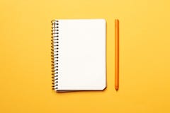 Notebook with pen on yellow background stock photography Notebook with pen on yellow background stock photography