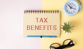 On a notepad the inscription TAX BENEFITS