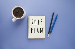 Notepad, pens and a cup of coffee on purple background. stock photos Notepad, pens and a cup of coffee on purple background. stock photos