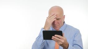 Notícia de Read Financial Bad do homem de negócios na tabuleta de toque e para gesticular desapontado fotografia de stock Notícia de Read Financial Bad do homem de negócios na tabuleta de toque e para gesticular desapontado fotografia de stock