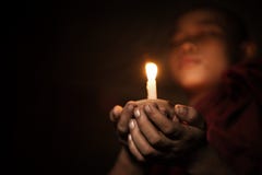 Novice with candlelight stock images Novice with candlelight stock images