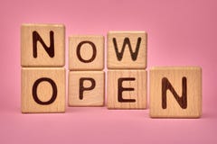 NOW OPEN text made with building blocks, business concept. Now open on pink background. Business service. Opening public places