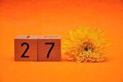 Number twenty seven with a yellow daisy stock photos Number twenty seven with a yellow daisy stock photos