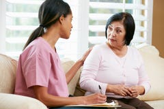 Nurse Discussing Records With Senior Female Patient