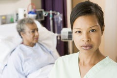 Nurse Standing In Patients Room Looking Serious Royalty Free Stock Photo Nurse Standing In Patients Room Looking Serious Royalty Free Stock Photo