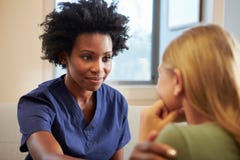 Nurse Treating Teenage Girl Suffering With Depression Nurse Treating Teenage Girl Suffering With Depression