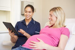 Nurse Using Digital Tablet In Meeting With Pregnant Woman royalty free stock photo Nurse Using Digital Tablet In Meeting With Pregnant Woman royalty free stock photo