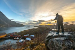 Nusfjord, Norway - November 17, 2018: Tourist take a photograph landscape at Nusfjord fishing village in Flakstad municipality in royalty free stock photography Nusfjord, Norway - November 17, 2018: Tourist take a photograph landscape at Nusfjord fishing village in Flakstad municipality in royalty free stock photography