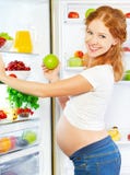 Nutrition and diet during pregnancy. Pregnant woman with fruits royalty free stock photography Nutrition and diet during pregnancy. Pregnant woman with fruits royalty free stock photography