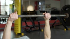 Närbild av den starka idrottsman nen som lyfter skivstången på idrottshallen, tyngdlyftning, sport stock video Närbild av den starka idrottsman nen som lyfter skivstången på idrottshallen, tyngdlyftning, sport stock video