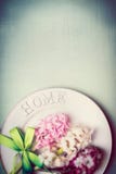 O ajuste da tabela da mola com placa, fita e os jacintos bonitos floresce, vista superior, beira, cor pastel fotografia de stock O ajuste da tabela da mola com placa, fita e os jacintos bonitos floresce, vista superior, beira, cor pastel fotografia de stock