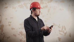 O mestre está contando o preço de trabalhos do reparo em um plano pela calculadora em um telefone filme O mestre está contando o preço de trabalhos do reparo em um plano pela calculadora em um telefone filme