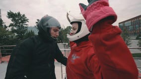 O treinador masculino instrui uma menina do skydiver antes de voar no túnel de vento vídeos de arquivo O treinador masculino instrui uma menina do skydiver antes de voar no túnel de vento vídeos de arquivo