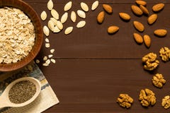 Oatmeal with nuts in bowl on brown background stock image Oatmeal with nuts in bowl on brown background stock image