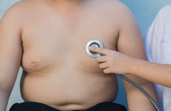 Obese asian boy check heart by stethoscope stock image Obese asian boy check heart by stethoscope stock image