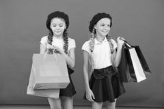 Obsessed with shopping and clothing malls. Shopaholic concept. Signs you are addicted to shopping. Kids cute schoolgirls stock photography Obsessed with shopping and clothing malls. Shopaholic concept. Signs you are addicted to shopping. Kids cute schoolgirls stock photography