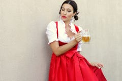 October fest concept.Beautiful german woman in typical oktoberfest dress dirndl holding a glass beer mug stock image October fest concept.Beautiful german woman in typical oktoberfest dress dirndl holding a glass beer mug stock image