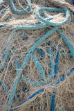 Off White Fishing Net with Blue Rope. Close up of a jumble of off white fishing net with off white, aquamarine and royal blue throughout the pile of netting Stock Image Off White Fishing Net with Blue Rope. Close up of a jumble of off white fishing net with off white, aquamarine and royal blue throughout the pile of netting Stock Image