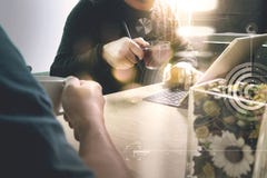 Office coffee break with two designer colleagues sitting chatting over cups of coffee,flower vase,digital tablet docking smart stock image Office coffee break with two designer colleagues sitting chatting over cups of coffee,flower vase,digital tablet docking smart stock image