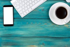 Office desk with copy space. Digital devices wireless keyboard, mouse and smartphone with empty screen on blue wooden table Royalty Free Stock Photo Office desk with copy space. Digital devices wireless keyboard, mouse and smartphone with empty screen on blue wooden table Royalty Free Stock Photo