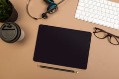 Office desk table with tablet keyboard headphones coffee and glasses Mock up template . Top view stock photo Office desk table with tablet keyboard headphones coffee and glasses Mock up template . Top view stock photo