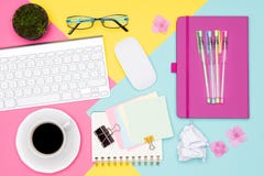 Office Desk Working Space Flat Lay. Top view photo of workspace with keyboard, notepad and coffee cup on pastel background. royalty free stock image Office Desk Working Space Flat Lay. Top view photo of workspace with keyboard, notepad and coffee cup on pastel background. royalty free stock image