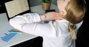 Office syndrome - woman suffering from neck pain while working with computer