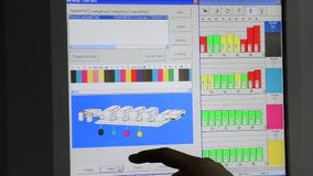 Offset print machine operator adjusts ink keys stock video Offset print machine operator adjusts ink keys stock video
