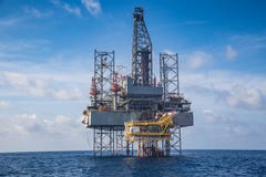 Offshore oil and gas drilling rig at the gulf of Thailand whil compleation on wellhead remote platform Stock Images Offshore oil and gas drilling rig at the gulf of Thailand whil compleation on wellhead remote platform Stock Images