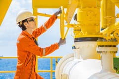 Production operator open valve to allow gas flowing to sea line pipe for sent gas and crude oil to central processing platform stock photography Production operator open valve to allow gas flowing to sea line pipe for sent gas and crude oil to central processing platform stock photography