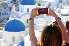 OIA, GREECE, September 19, 2018 A tourist takes a photograph using a phone royalty free stock photography OIA, GREECE, September 19, 2018 A tourist takes a photograph using a phone royalty free stock photography