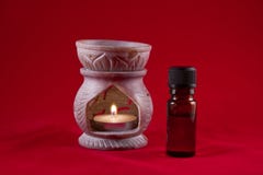 Oil burner with bottle on red background stock photography Oil burner with bottle on red background stock photography