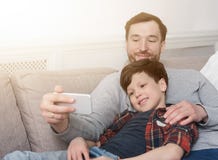 Ojciec i jego syn bierze selfie w domu zdjęcia stock Ojciec i jego syn bierze selfie w domu zdjęcia stock
