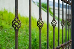 Old beautiful decorative metal wrought fence with artistic forging. Iron rusty guardrail need to be painting and repaired Stock Image Old beautiful decorative metal wrought fence with artistic forging. Iron rusty guardrail need to be painting and repaired Stock Image