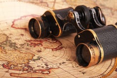 Old binoculars on antique map