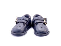 Old black Baby shoe made from leather stock photos Old black Baby shoe made from leather stock photos