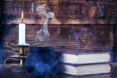 Old Books Of Magic And Witch Pot With Smoke And Candle Royalty Free Stock Image