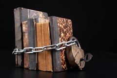 Old books strapping a shiny chain. Forbidden literature locked with a padlock
