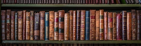Old books on wooden shelf.. Concept on the theme of history, nostalgia, old age. Retro style