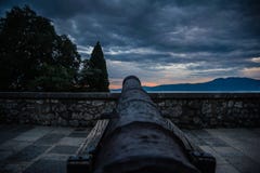 Old cast canon overlooking sea shot in sunset stock photo Old cast canon overlooking sea shot in sunset stock photo