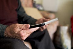 Old caucasian man using a tablet royalty free stock image Old caucasian man using a tablet royalty free stock image