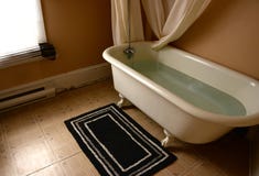 Old claw foot bathtub in old bathroom stock photography Old claw foot bathtub in old bathroom stock photography
