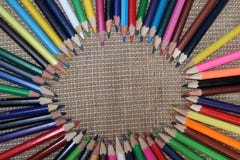 Old color pencils on burlap background stock photos Old color pencils on burlap background stock photos