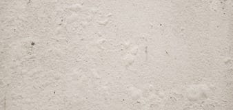 Old concrete walls have paint stains and rough surface marks, texture, gray, cream, light for the background.