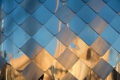 Old, dirty aluminum metal wall facade panel with rhombus, similar to the scales and tiles. Reflection of sunset. stock photo Old, dirty aluminum metal wall facade panel with rhombus, similar to the scales and tiles. Reflection of sunset. stock photo