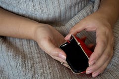 Old empty red wallet in the hands of women. The concept of poverty stock image Old empty red wallet in the hands of women. The concept of poverty stock image