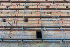 Old brick facade with scaffolding for renovation stock images Old brick facade with scaffolding for renovation stock images