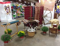 Old Fashioned Textiles Display Featuring Cotton, a Loom, Spinning Wheel, and Sewing Machine at a County Fair, Pennsylvania, USA royalty free stock photography Old Fashioned Textiles Display Featuring Cotton, a Loom, Spinning Wheel, and Sewing Machine at a County Fair, Pennsylvania, USA royalty free stock photography