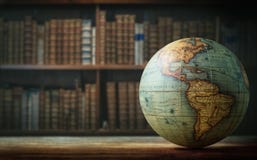 Old globe on bookshelf background. Selective focus. Retro style. Royalty Free Stock Photography Old globe on bookshelf background. Selective focus. Retro style. Royalty Free Stock Photography